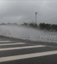 Cars create beautiful water waves when driving through flooded road