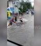 Pedestrians wade through flood water in the Philippines