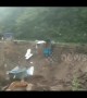 Portacabin and truck fall into river during massive mudslide in China
