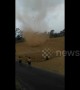 Fearless kids run into massive dust devil in Indonesia