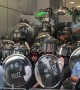 Hong Kong riot police violently shove journalist