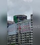Demolition worker spotted swinging sledgehammer at 12-storey apartment block in Thailand