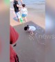 Chinese girl refuses to give up as the sea keeps on washing away her heart drawing
