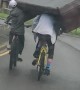 Squad of Cyclists Carry a Couch