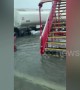Airport bus drives passengers across flooded tarmac after tropical storm