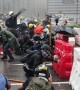 Hong Kong protesters take cover behind barricades as police fire tear gas