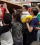 Customers climb under store shutter as China's first Costco shop opens
