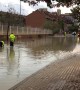 Road maintenance workers attempt to drain road after storm batters Madrid