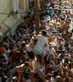 Residents in Spain battle to climb a pole during the infamous La Tomatina festival