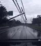 Terrifying moment electricity pylons are blown onto car during Thai storm