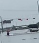 Water skiing down flooded street from Tropical Storm Imelda