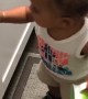Frustrated Toddler Tries to Open Cabinet
