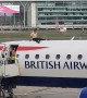 Man Sits on top of Plane at London City Airport