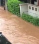Kid floats down tube in flooded streets of Jakarta