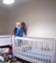 Boy Helps Brother out of Crib