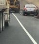 Truck Pushes Car Onto Freeway Shoulder