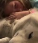 Bedtime snuggles between little girl and her gentle wolfdog
