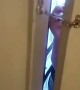Girl Unlocks a Chain Door from the Outside