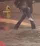 Boy Carries Fellow Students Across Flooded Street