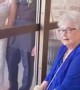 Bride visits her grandmother through glass on wedding day
