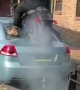 Biker Does Burnout on Back of Car