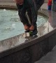 Man Rides a Tiny Bike on a Fountain