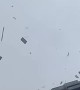 Building Materials Fly Off a Building During a Storm