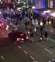 Police SUV runs through crowd crossing the street