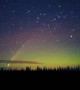 Comet Drifts Though Northern Lights