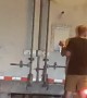 Man Clings to the Back of 18-Wheeler on Freeway