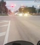 Motorcyclist Has Close Call with Red Light Running Semi