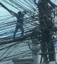 Worker Climbs Along Electric Wires