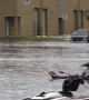 People ride jet skis through flooded Miami streets