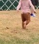 Little Girls Spins and Falls Down in Grass