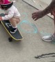 Young Girls Showcases Skateboard Skill with Dad's Help