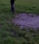 Kid Makes an Unexpected Jump into Mud Puddle