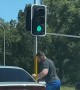 Angry Man Attacks Car at Intersection