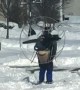 Heavy snow no match for guy wearing skis and high powered fan