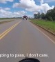Motorcyclist Passes Underneath Large Vehicle on the Road