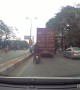 Scooter Tries to Squeeze Past Truck