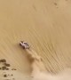 Full throttle truck drives up insanely steep sand dune