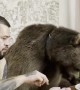 Bear Enjoying a Snack With His Human Best Friend