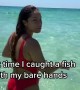 Woman in the ocean catches fish with her bare hands  