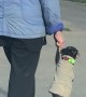 Dog and Owner Cross Street Holding Hands