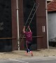 Man Deftly Ascends Building With Ladder