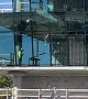 Construction Workers Break Large Glass Window