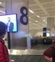 Man Appears to Direct Luggage at Barcelona Airport Baggage Claim