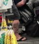 Man Struggles with Baby Stroller in Store