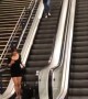 Suitcase Slides Down Escalator