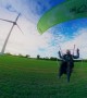 Paramotor Flies Around Wind Turbine